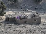 Residents gather near a damaged house two days after Pakistani air strikes struck the Barmal district of eastern Paktika province.