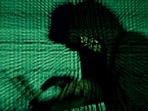 A man holds a laptop computer as cyber code is projected on him in this illustration picture taken on May 13, 2017