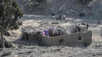 Residents gather near a damaged house two days after Pakistani air strikes struck the Barmal district of eastern Paktika province. (AFP)