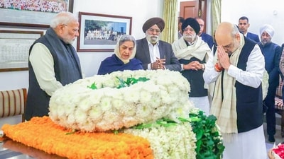 Union home minister Amit Shah pays his last respects to the mortal remains of former prime minister Manmohan Singh at his residence in New Delhi on Friday. Prime Minister Narendra is also present. (Amit Shah-X) Union home minister Amit Shah pays his last respects to the mortal remains of former prime minister Manmohan Singh at his residence in New Delhi on Friday. Prime Minister Narendra is also present. (Amit Shah-X)