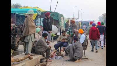Farmers keep themselves warm from a bonfire on a cold winter day at Khanauri border in Sangrur district on Saturday. (PTI) Farmers keep themselves warm from a bonfire on a cold winter day at Khanauri border in Sangrur district on Saturday. (PTI)