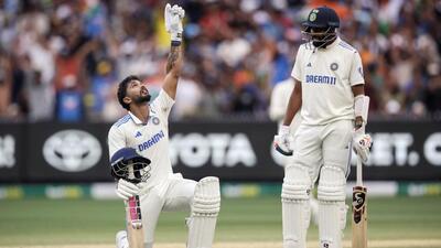 India's Nitish Kumar Reddy celebrates his century with Mohammed Siraj watching in the MCG Test on Saturday. (AFP)