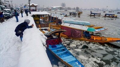 Tourists around the Dal lake also took in the frozen view of the water body (PTI) Tourists around the Dal lake also took in the frozen view of the water body (PTI)