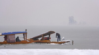While tourists enjoyed, locals were seen clearing snow which had disrupted the flow of normal life by blocking vehicles and boats (PTI) While tourists enjoyed, locals were seen clearing snow which had disrupted the flow of normal life by blocking vehicles and boats (PTI)