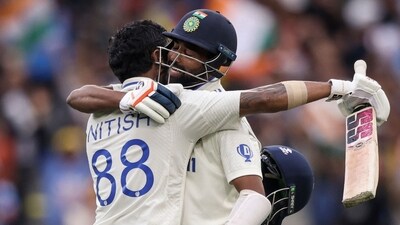 India's Nitish Kumar Reddy (L) celebrates with Mohammed Siraj after passing 100 on day three of the fourth cricket Test match against Australia. (AFP)