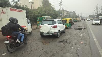 The road stretch between Hero Honda Chowk and Umang Bhardwaj Chowk is in a bad condition and has developed large potholes, making commuting quite difficult on the stretch. (HT PHOTO) The road stretch between Hero Honda Chowk and Umang Bhardwaj Chowk is in a bad condition and has developed large potholes, making commuting quite difficult on the stretch. (HT PHOTO)