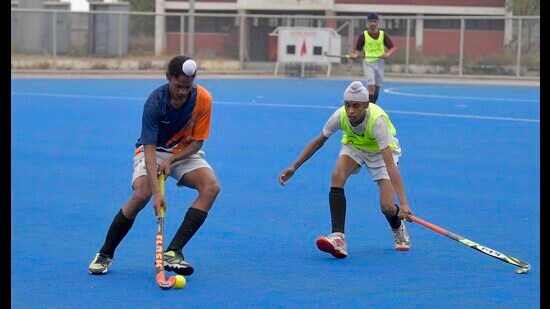 Players vie for ball during a hockey match in Ludhiana on Saturday. (Manish/HT)