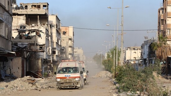 TOPSHOT - Ambulances transport wounded Palestinians from the Kamal Adwan Hospital to the al-Shifa hospital in Gaza City, on December 28, 2024, amid the ongoing war between Israel and the Hamas militant group. Gaza health officials said on December 28, that Israeli forces detained the director of a hospital in the north, which the World Health Organization said was put out of service by an Israeli raid. On December 27, the Israeli military said it had launched an operation in the area of Kamal Adwan Hospital, alleging the facility was a "key stronghold for terrorist organisations". (Photo by Omar AL-QATTAA / AFP)