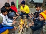 Rohtak: Children sit around a bonfire to keep themselves warm on a cold winter day. Rohtak: Children sit around a bonfire to keep themselves warm on a cold winter day.
