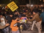 Police personnel try to stop aspirants protesting against the alleged paper leak and irregularities in the BPSC 70th Integrated Combined Competitive Examination (CCE), in Patna, Sunday, Dec. 29, 2024.