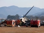 Firefighters and rescue team members work at Muan International Airport in Muan, South Korea after the plane caught fire.