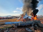 Fire and smoke rise from the tail section of a Jeju Air Boeing 737-800 series aircraft after the plane crashed and burst into flames at Muan International Airport.