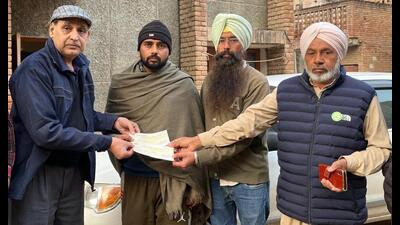 A compensation cheque being handed over to one of the families in Bathinda. (HT Photo) A compensation cheque being handed over to one of the families in Bathinda. (HT Photo)