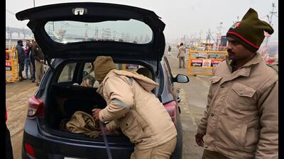 Policemen checking a vehicle entering mela area in Prayagraj. (HT photo) Policemen checking a vehicle entering mela area in Prayagraj. (HT photo)