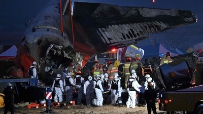 Firefighters and rescue personnel at the site of a Jeju Air plane crash at Muan International Airport (AFP) Firefighters and rescue personnel at the site of a Jeju Air plane crash at Muan International Airport (AFP)