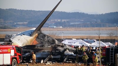 Rescue personnel work near the tail section of a Jeju Air Boeing 737-800 series aircraft after the plane crashed and burst into flames in South Korea. (AFP) Rescue personnel work near the tail section of a Jeju Air Boeing 737-800 series aircraft after the plane crashed and burst into flames in South Korea. (AFP)