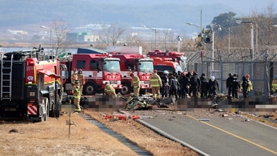Rescue personnel are seen near casualties at the scene where a Jeju Air Boeing 737-800 series aircraft crashed and burst into flames at Muan International Airport. (AFP) Rescue personnel are seen near casualties at the scene where a Jeju Air Boeing 737-800 series aircraft crashed and burst into flames at Muan International Airport. (AFP)