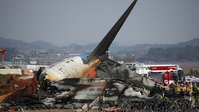 Rescue workers take part in a salvage operation at the site where an aircraft crashed after it went off the runway. (REUTERS)