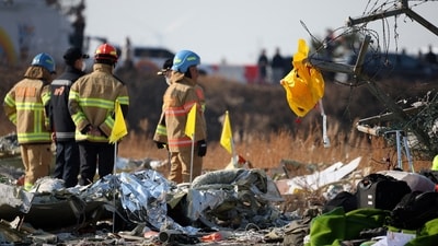 A life jacket hangs on fencing next to the wreckage of an aircraft that crashed after it went off the runway at Muan International Airport, in Muan, South Korea,&nbsp; (REUTERS)