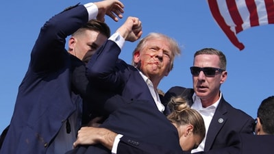 Secret Service agents shield Donald Trump moments after he was shot at his rally in Butler, Pennsylvania, on July 14 (AP) Secret Service agents shield Donald Trump moments after he was shot at his rally in Butler, Pennsylvania, on July 14 (AP)