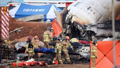 Firefighters carry the body of a passenger from the wreckage of an aircraft that crashed after it went off the runway at Muan International Airport, in Muan, South Korea, December 29, 2024. (Reuters)