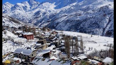 Snow covered Keylong town oon a bright sunny day after fresh snowfall, on Sunday. (Aqil Khan /HT)
