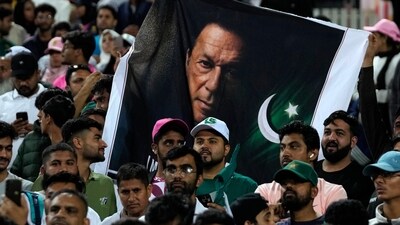 Pakistan's cricket fans hold a poster with imprisoned former premier Imran Khan following the third International cricket match between South Africa and Pakistan, at the Wanderers stadium in Johannesburg, South Africa, (AP) Pakistan's cricket fans hold a poster with imprisoned former premier Imran Khan following the third International cricket match between South Africa and Pakistan, at the Wanderers stadium in Johannesburg, South Africa, (AP)