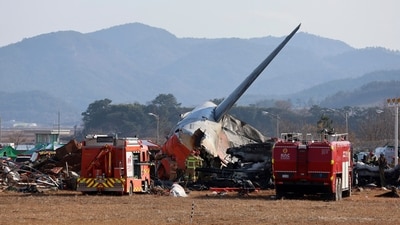 Firefighters and rescue team members work at Muan International Airport in Muan. (AP) Firefighters and rescue team members work at Muan International Airport in Muan. (AP)