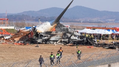 Firefighters and rescue team members work near the wreckage of a passenger plane at Muan International Airport in Muan, South Korea. (AP) Firefighters and rescue team members work near the wreckage of a passenger plane at Muan International Airport in Muan, South Korea. (AP)