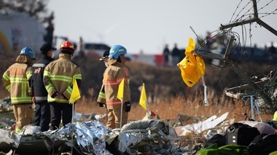 A life jacket hangs on fencing next to the wreckage of an aircraft that crashed after it went off the runway at Muan International Airport, in Muan, South Korea, December 29, 2024. (Reuters)