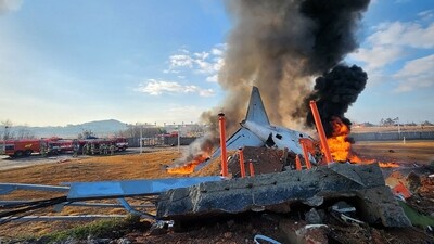 Fire and smoke rise from the tail section of a Jeju Air Boeing 737-800 series aircraft after the plane crashed and burst into flames at Muan International Airport. (AFP) Fire and smoke rise from the tail section of a Jeju Air Boeing 737-800 series aircraft after the plane crashed and burst into flames at Muan International Airport. (AFP)