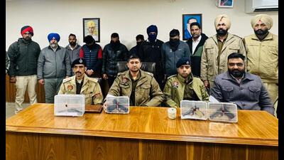 The accused (with their faces covered) after being arrested in Tarn Taran. (HT Photo) The accused (with their faces covered) after being arrested in Tarn Taran. (HT Photo)