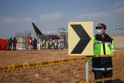 Rescue workers take part in a salvage operation at the site where an aircraft went off the runway at Muan International Airport in South Korea. (REUTERS)