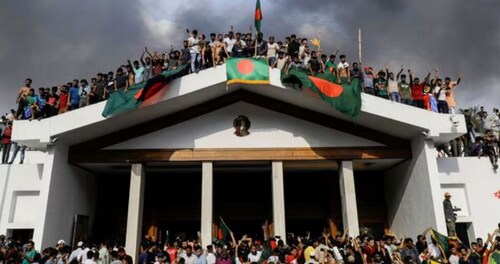 Anti-government protestors display Bangladesh’s national flag as they storm Prime Minister Sheikh Hasina’s palace in Dhaka on August 5 Anti-government protestors display Bangladesh’s national flag as they storm Prime Minister Sheikh Hasina’s palace in Dhaka on August 5