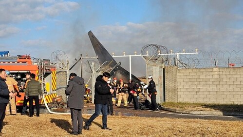 Firefighters and rescue team members work at the Muan International Airport in Muan, South Korea, Sunday, Dec. 29, 2024. (AP) Firefighters and rescue team members work at the Muan International Airport in Muan, South Korea, Sunday, Dec. 29, 2024. (AP)