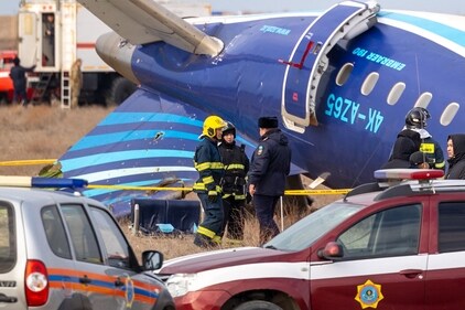 Emergency specialists work at the crash site of an Azerbaijan Airlines passenger jet near the western Kazakh city of Aktau. (AFP) Emergency specialists work at the crash site of an Azerbaijan Airlines passenger jet near the western Kazakh city of Aktau. (AFP)