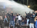 Police use water canon on aspirants during a march against alleged paper leak and irregularities in the BPSC 70th Integrated Combined Competitive Examination (CCE) 2024 at JP Golamber in Patna, Bihar on Sunday. (Santosh Kumar/ Hindustan Times)