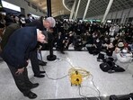 Jeju Air CEO Kim E-bae , left, and other executive members bow in apology to relatives of passengers at the Muan International Airport in Muan, South Korea on Sunday. Jeju Air CEO Kim E-bae , left, and other executive members bow in apology to relatives of passengers at the Muan International Airport in Muan, South Korea on Sunday.