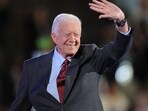 Jimmy Carter death: Flags at half-staff to gun salutes, what we can expect after former president's passing (Photo by Robyn BECK / AFP)