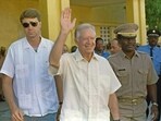 Former US President Jimmy Carter (C) waves after meeting 22 September 1990 in Port-au-Prince with authorities about the upcoming elections in Haiti. (AFP/File)