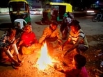 People getting warm themselves with bonfire during a cold wave