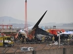 Firefighters and recovery teams work at the scene where a Jeju Air Boeing 737-800 series aircraft crashed and burst into flames at Muan International Airport on December 30. (AFP)