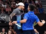 Novak Djokovic of Serbia (R) and doubles partner Nick Kyrgios of Australia (L) celebrate winning their men's doubles match.