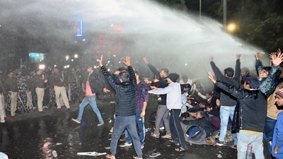 Police use water canon on aspirants during a march against alleged paper leak and irregularities in the BPSC 70th Integrated Combined Competitive Examination (CCE) 2024 at JP Golamber in Patna, Bihar on Sunday. (Santosh Kumar/ Hindustan Times)