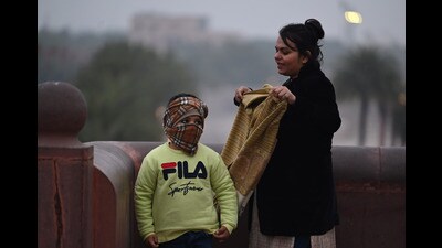 A mother covers her son’s face as a cold wave grips Lucknow on Monday. (Deepak Gupta/ HT) A mother covers her son’s face as a cold wave grips Lucknow on Monday. (Deepak Gupta/ HT)