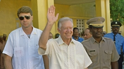 Former US President Jimmy Carter (C) waves after meeting 22 September 1990 in Port-au-Prince with authorities about the upcoming elections in Haiti. (AFP/File) (AFP) Former US President Jimmy Carter (C) waves after meeting 22 September 1990 in Port-au-Prince with authorities about the upcoming elections in Haiti. (AFP/File) (AFP)