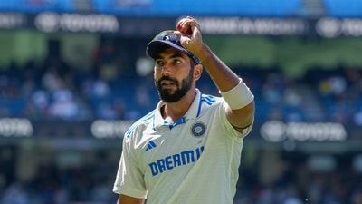 India's Jasprit Bumrah holds up the ball as he leaves the field after taking the five wickets during play on the last day of the fourth cricket Test against Australia. (AP) India's Jasprit Bumrah holds up the ball as he leaves the field after taking the five wickets during play on the last day of the fourth cricket Test against Australia. (AP)