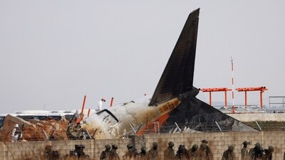 Military personnel work at the site where an aircraft of Jeju Air went off the runway and crashed at the Muan International Airport. (Reuters)