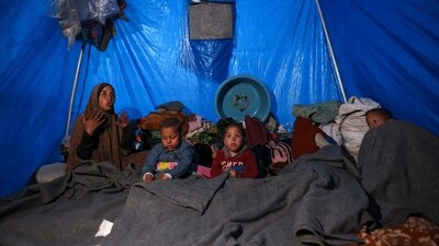 A woman sits next to her children inside a shelter at a camp for displaced Palestinians in Khan Yunis, in the southern Gaza Strip. (AFP) A woman sits next to her children inside a shelter at a camp for displaced Palestinians in Khan Yunis, in the southern Gaza Strip. (AFP)