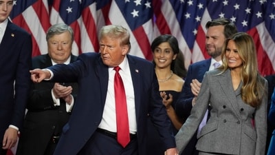 Donald Trump holds hands with former first lady Melania Trump after speaking to supporters at the Palm Beach County Convention Center. (AP File). (AP)